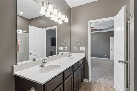 a bathroom with a sink double vanity and a mirror
