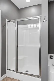 a bathroom with a glass shower door
