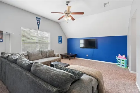 a bedroom with furniture and a flat screen tv