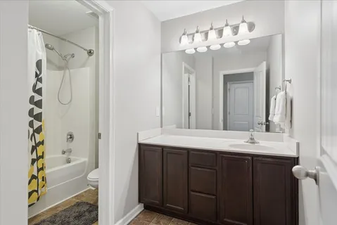 a bathroom with a sink vanity granite shower and a mirror