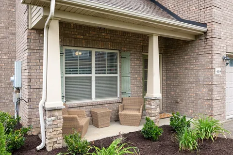 a front view of a house with outdoor seating and plants