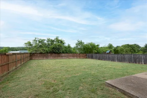 a view of a swimming pool with a yard