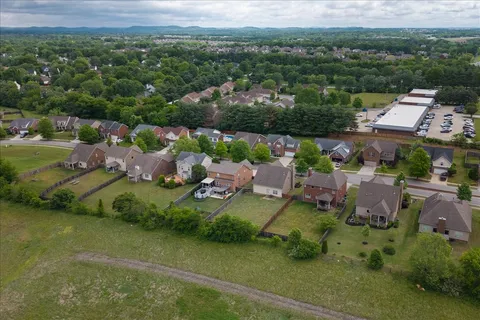 an aerial view of a house with yard swimming pool and outdoor seating