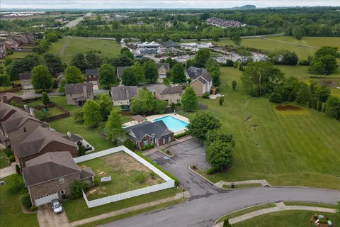 an aerial view of residential houses with outdoor space and river