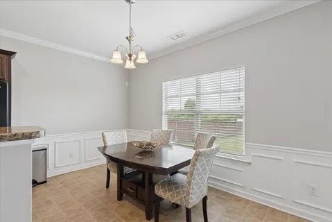 a view of a dining room with a table and chairs