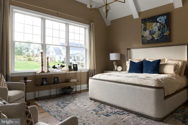 a spacious bedroom with a bed and a couch