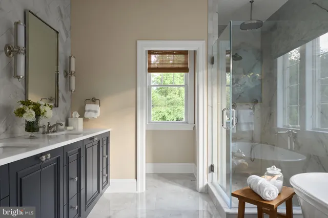 a bathroom with a granite countertop sink a toilet and shower