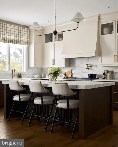 a kitchen with a dining table chairs and white appliances