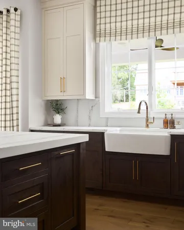 a kitchen with a sink cabinets and a large window