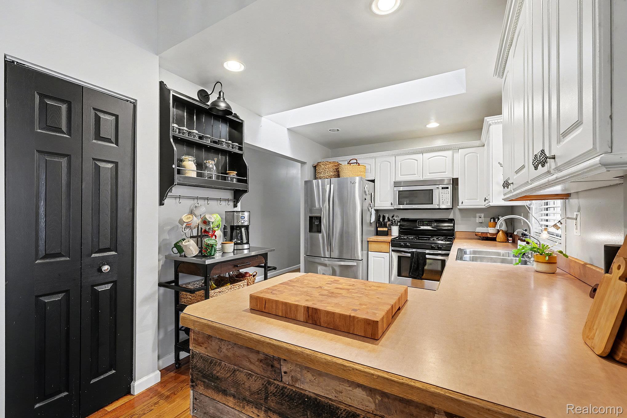 62915 Chubb Road Ray, MI 48096 - Photo 10 of 27 Kitchen featuring light countertops, appliances with stainless steel finishes, white cabinetry, recessed lighting, and a peninsula
