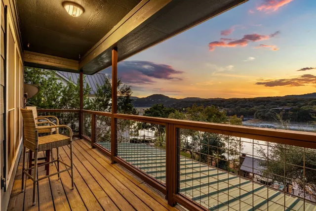 a view of balcony with wooden floor and fence