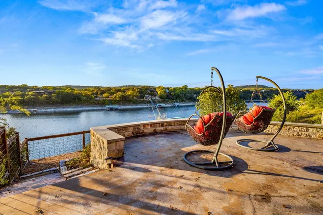a view of a lake with a table and chairs