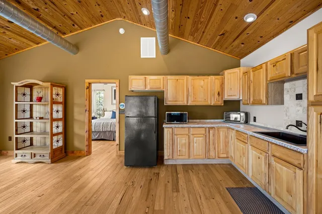 a kitchen with refrigerator and window