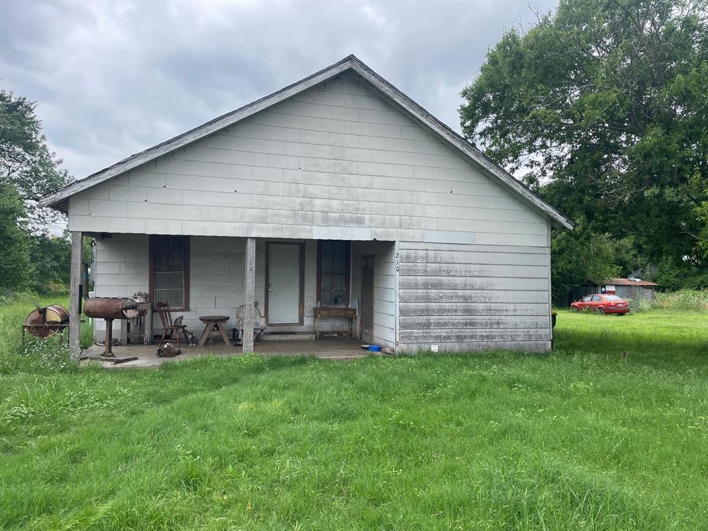 210 East Colorado Street Groesbeck, TX 76642 - Photo 2 of 2 a front view of house with yard and outdoor seating