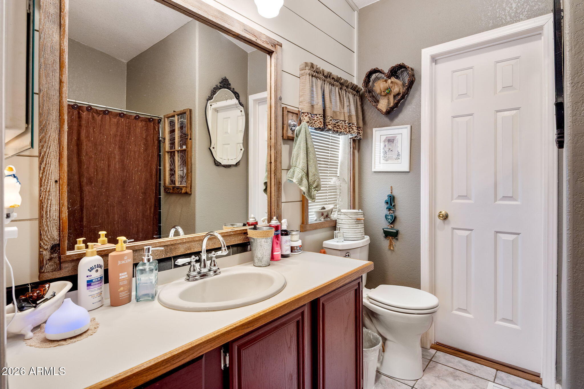 3069 Aspen Road Overgaard, AZ 85933 - Photo 14 of 40 a bathroom with a sink a toilet and a mirror