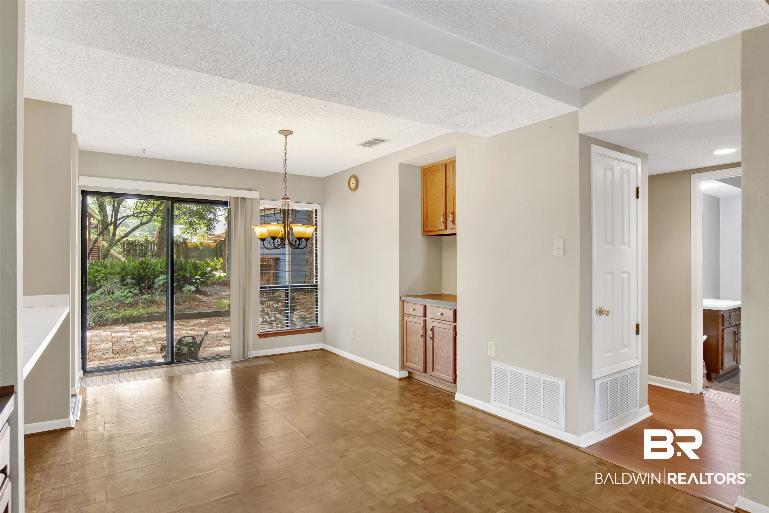 126 Montclair Loop Daphne, AL 36526 - Photo 6 of 25 Unfurnished dining area with a textured ceiling, a chandelier, and parquet flooring