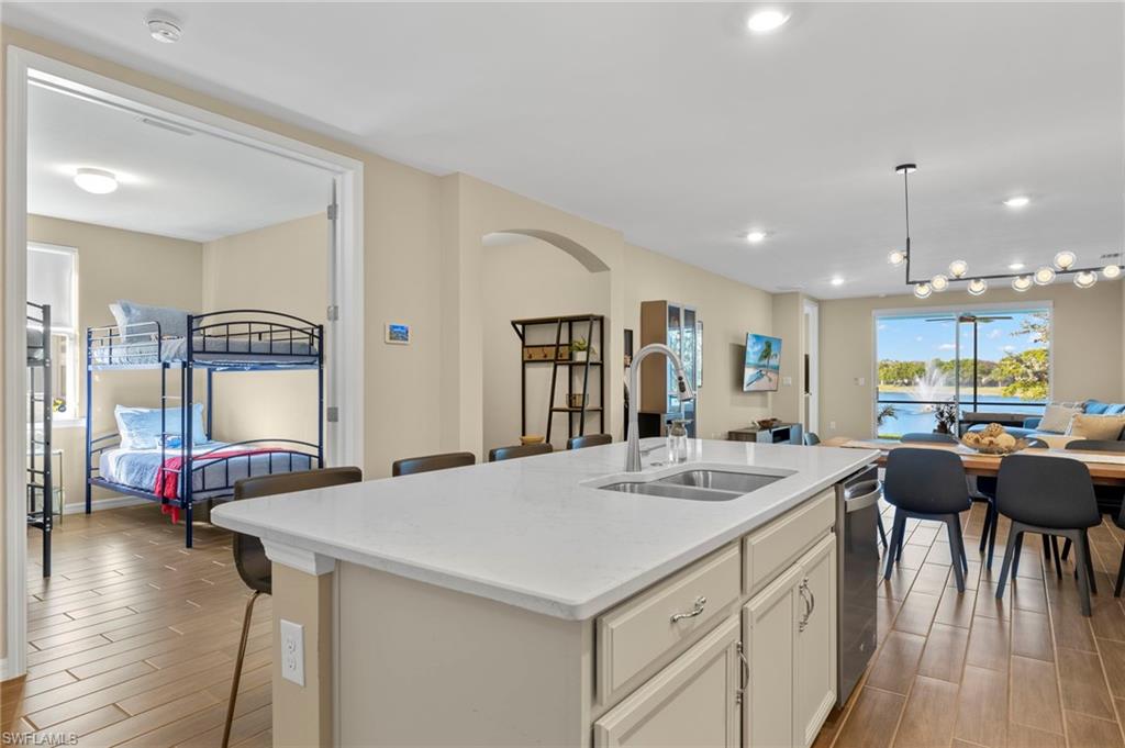 14644 Edgewater Circle Naples, FL 34114 - Photo 5 of 39 a kitchen with stainless steel appliances kitchen island granite countertop a sink and a refrigerator