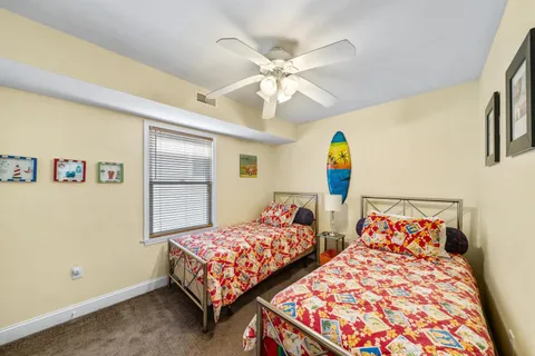 a bedroom with two beds and a window