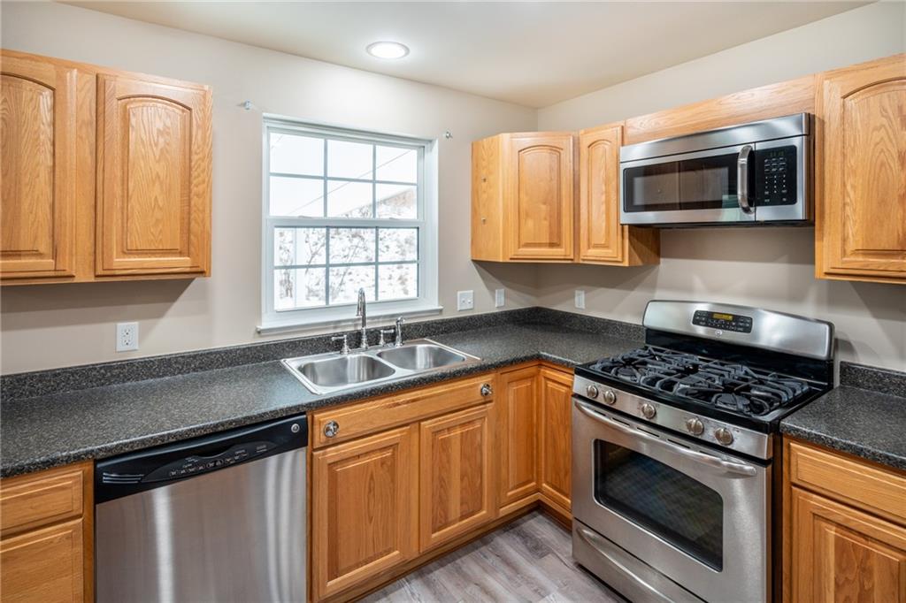 500 Walnut Drive McKees Rocks, PA 15136 - Photo 14 of 40 a kitchen with stainless steel appliances granite countertop a sink stove and microwave
