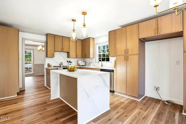a kitchen with stainless steel appliances a sink stove and refrigerator