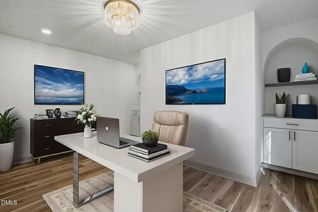 wooden floor in an empty room with a chandelier