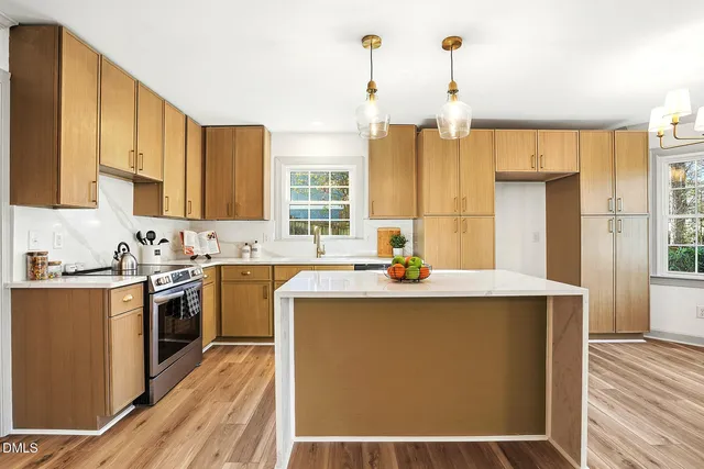 a kitchen that has a sink and a stove in it
