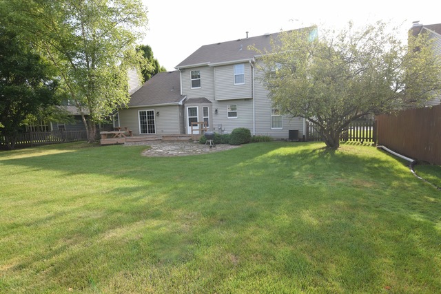 976 Lewis Road Geneva, IL 60134 - Photo 17 of 18 a view of a house with a big yard and large trees