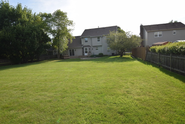 976 Lewis Road Geneva, IL 60134 - Photo 18 of 18 a backyard of a house with lots of green space