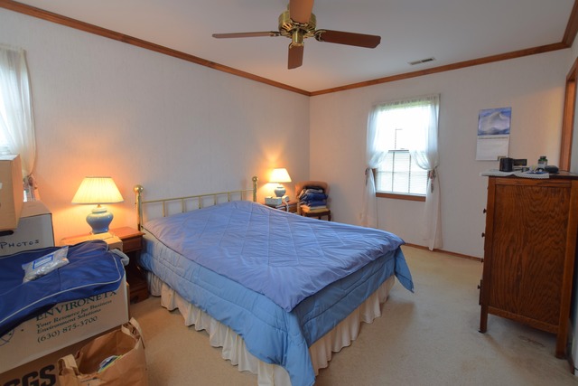976 Lewis Road Geneva, IL 60134 - Photo 7 of 18 a bed room with a bed and a lamp