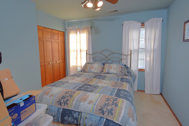 976 Lewis Road Geneva, IL 60134 - Photo 8 of 18 a bedroom with a bed and a chandelier