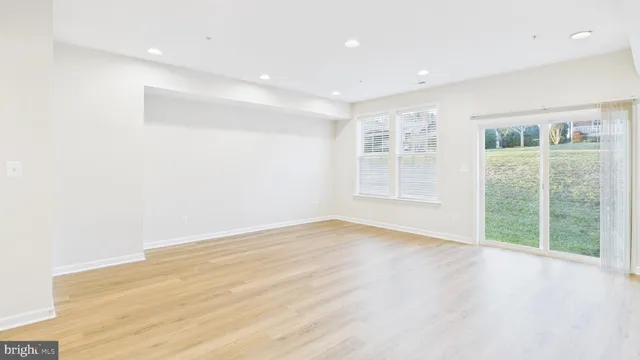 a kitchen with stainless steel appliances a stove top oven a sink a refrigerator and cabinets