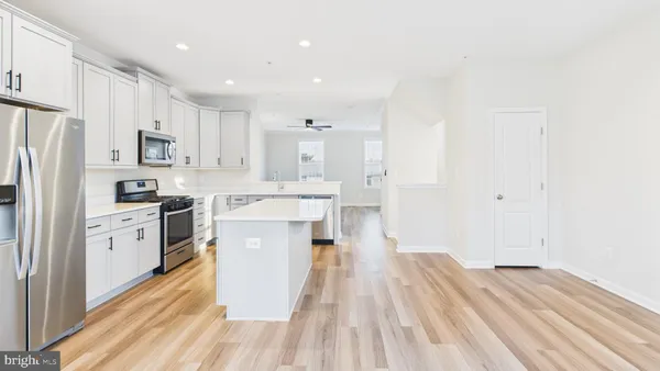 a kitchen with stainless steel appliances a refrigerator sink and cabinets