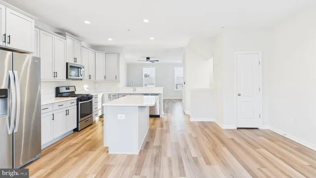 a kitchen with stainless steel appliances a refrigerator sink and cabinets