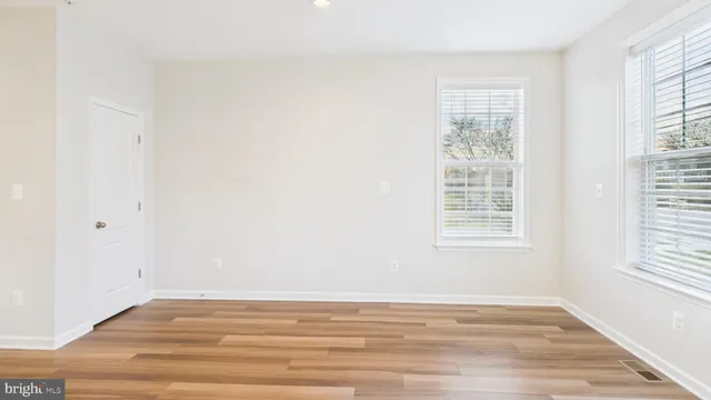 a view of an entryway with wooden floor