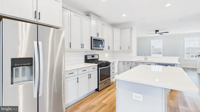 a view of a livingroom with wooden floor and stairs