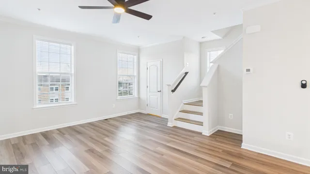 a view of entryway and hall with wooden floor