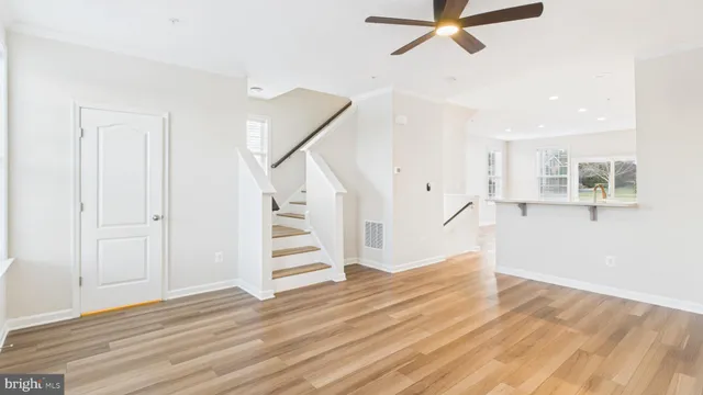 a view of entryway with furniture and wooden floor