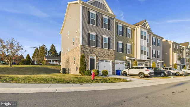a view of a hallway with wooden floor and entryway