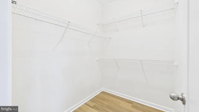 a view of a small space with wooden floor and a window