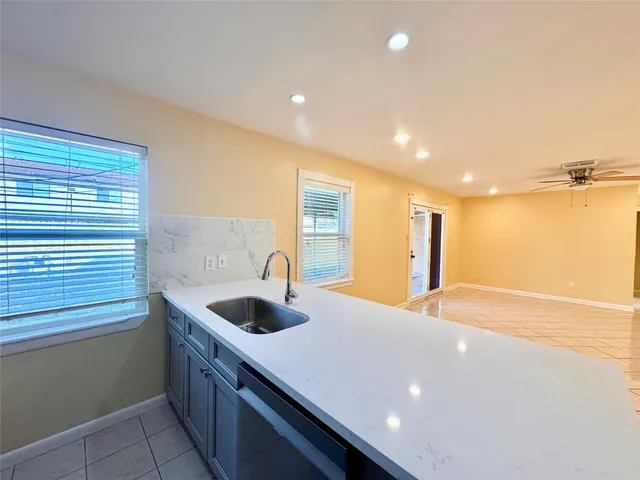 a kitchen with a sink and a refrigerator
