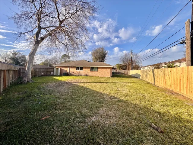 a view of yard with swimming pool and green space