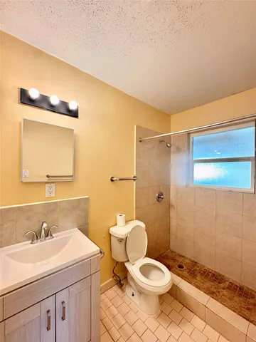 a bathroom with a sink toilet and a mirror