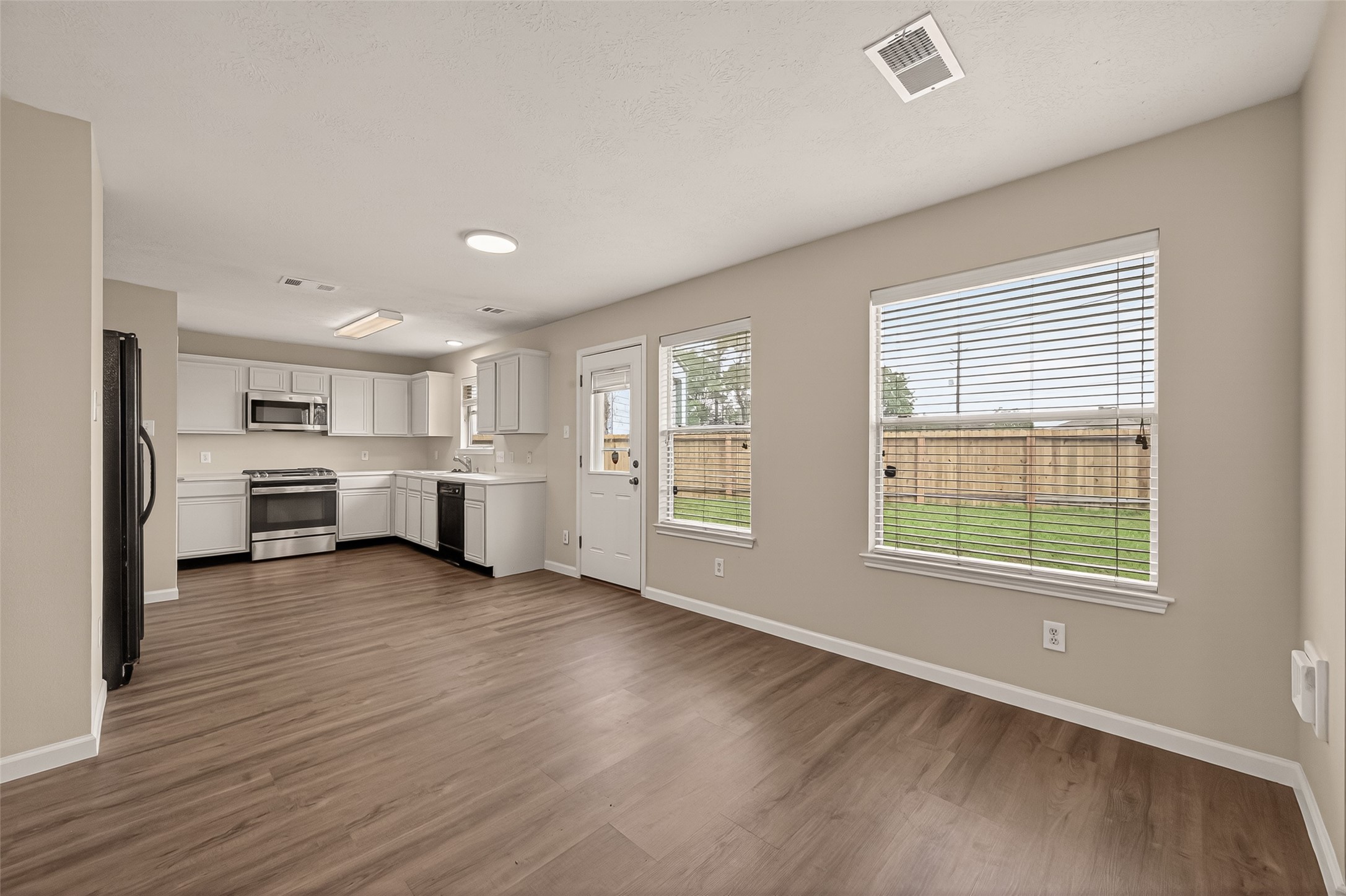 2751 Spring Colony Drive Spring, TX 77386 - Photo 11 of 47 a view of a room with a large window and wooden floor