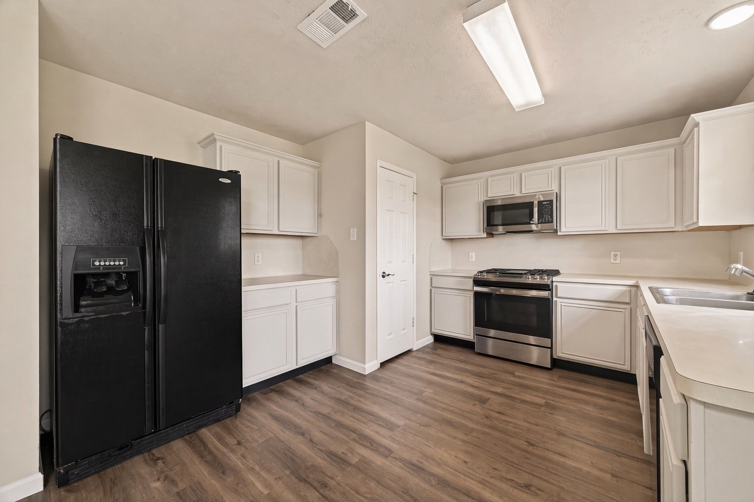 2751 Spring Colony Drive Spring, TX 77386 - Photo 15 of 47 a kitchen with a refrigerator and a stove top oven