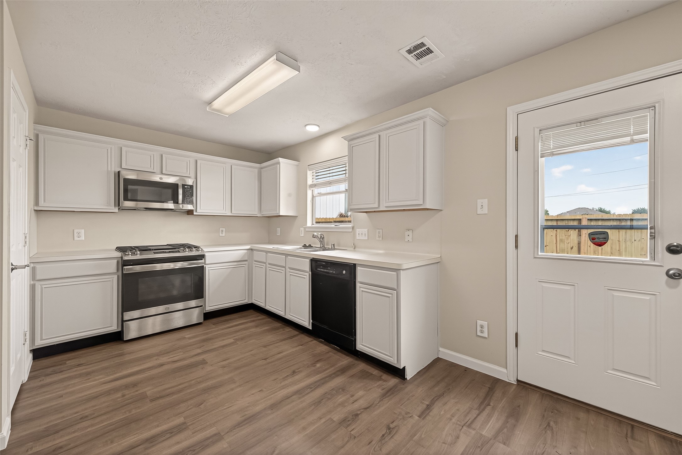 2751 Spring Colony Drive Spring, TX 77386 - Photo 17 of 47 a kitchen with a white cabinets and window