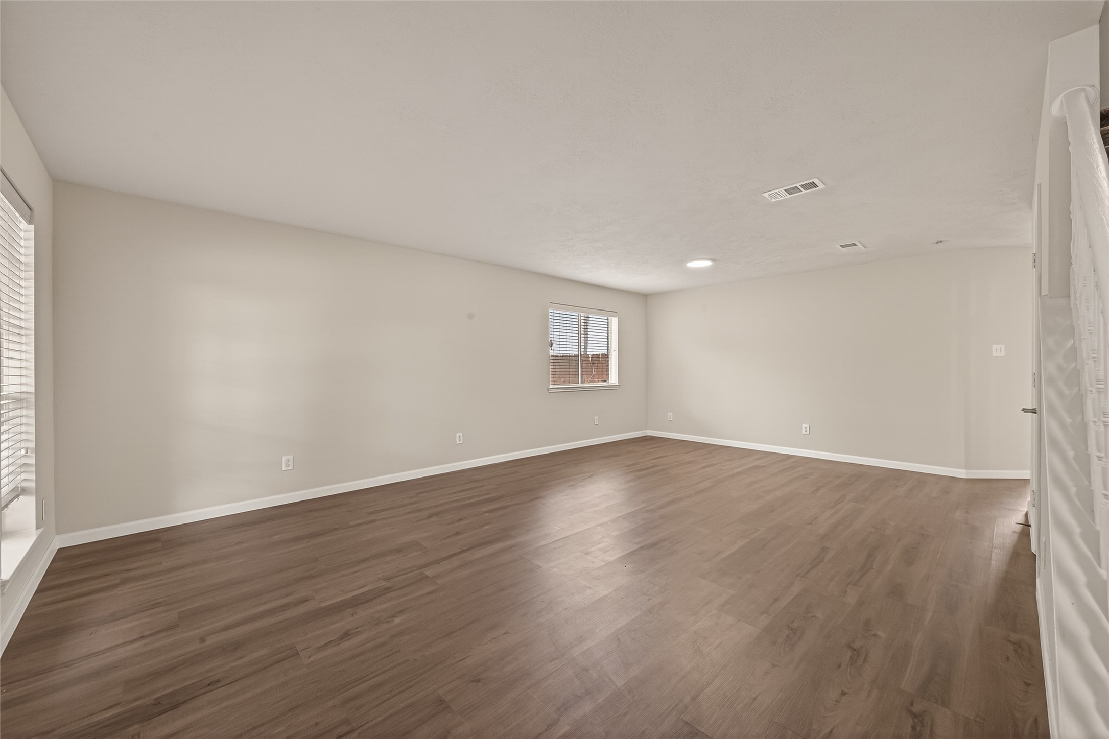 2751 Spring Colony Drive Spring, TX 77386 - Photo 6 of 47 a view of an empty room with wooden floor and a window