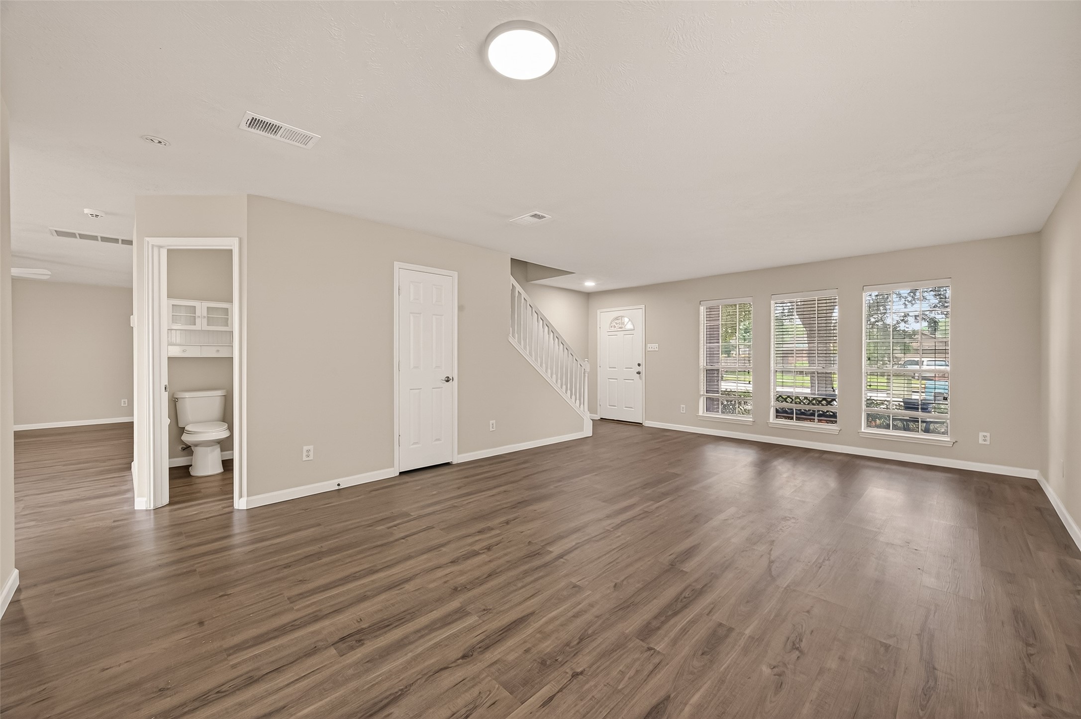 2751 Spring Colony Drive Spring, TX 77386 - Photo 8 of 47 an empty room with wooden floor and windows
