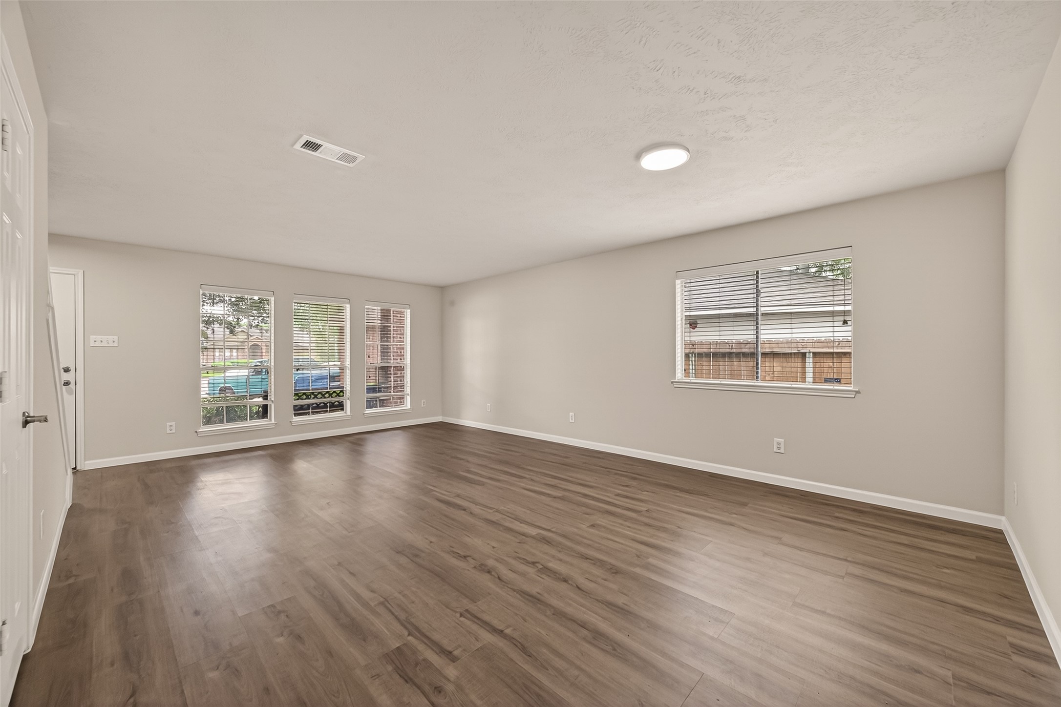 2751 Spring Colony Drive Spring, TX 77386 - Photo 9 of 47 a view of an empty room with wooden floor and a window