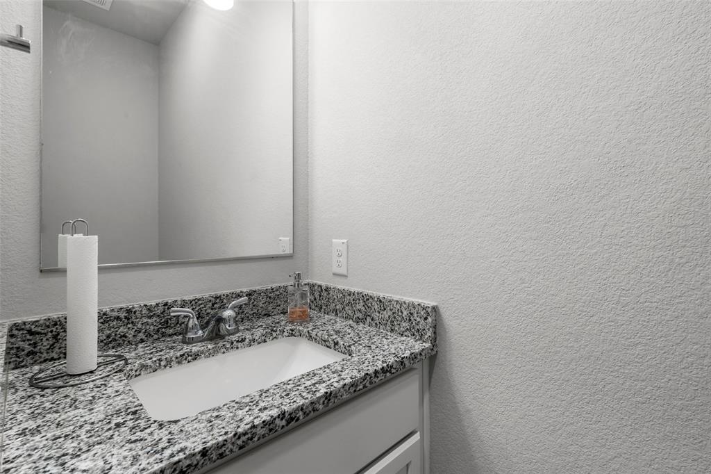 3525 Beutel Road Lorena, TX 76655 - Photo 19 of 34 a bathroom with a granite countertop sink and a mirror