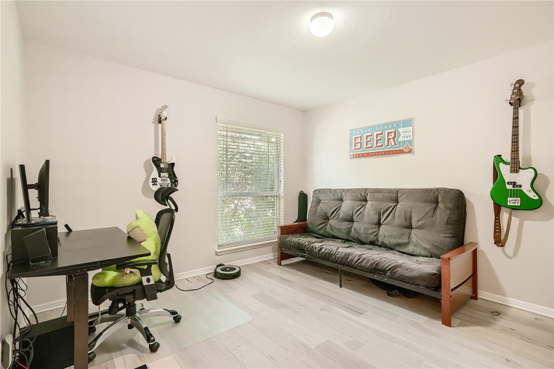 7108 Hester Road Austin, TX 78725 - Photo 10 of 25 a living room with furniture a window and gym equipment